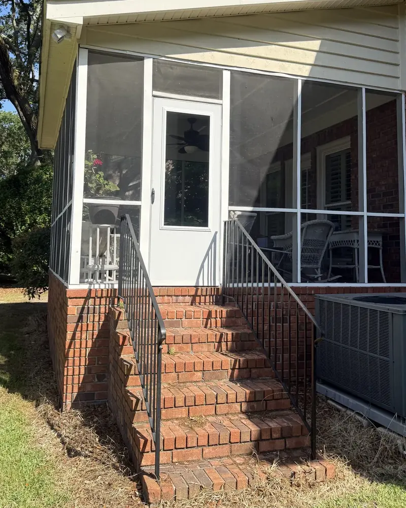 Screened porch with brick steps before conversion