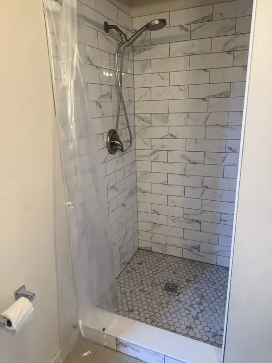 Marble-look tile walk-in shower