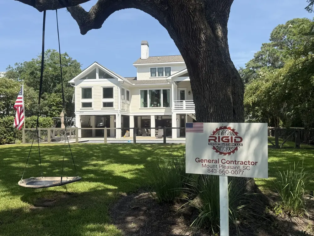 The 1914 Sullivan's Island house renovated by Rigid Construction, with the Rigid yard sign under a live oak